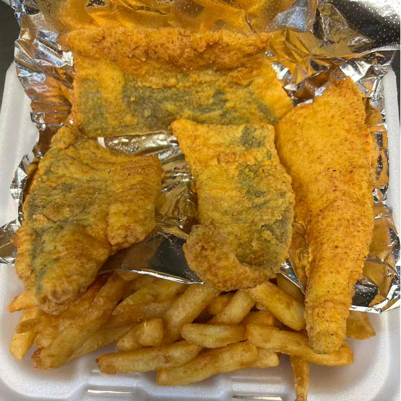 Fried whiting fish served with crispy fries at Cajun Claws & Wing, a Seafood Restaurant in Hartsville