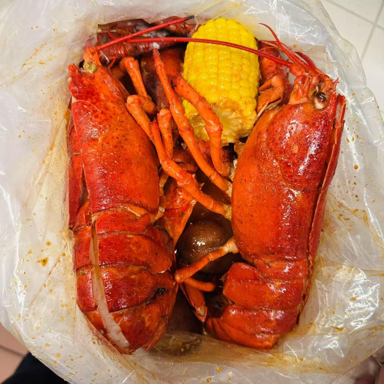 Cajun-Corner-seafood-restaurant-Twin-Lobster-Fries-Everett Twin Lobster Two whole lobsters with corn and potatoes at Cajun Corner, a seafood Restaurant in Everett