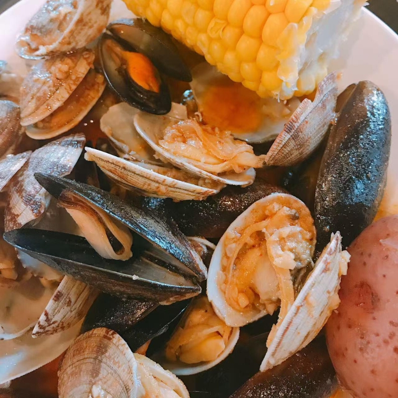 Boiled clams, mussels with corn and potato at Cajun Express, a Seafood Restaurant in St Paul