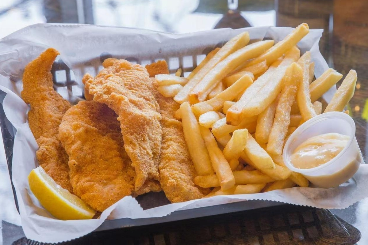Breaded fish strips, fries with sauce and lemon at Cajun Express, a Seafood Restaurant in St Paul