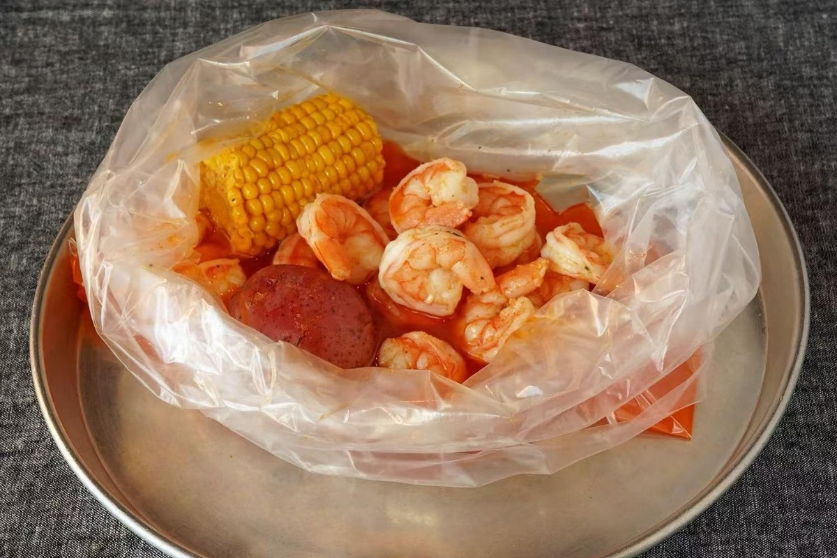 Cooked shrimp with corn and potato in sauce at Cajun Express, a Seafood Restaurant in St Paul