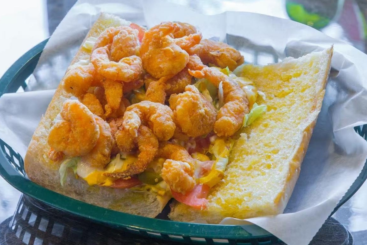 Fried shrimp loaded sandwich with veggies at Cajun Express, a Seafood Restaurant in St Paul