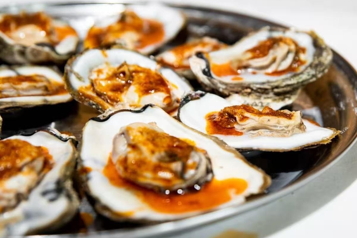 Saucy seasoned baked oysters on half shell at Cajun Express, a Seafood Restaurant in St Paul