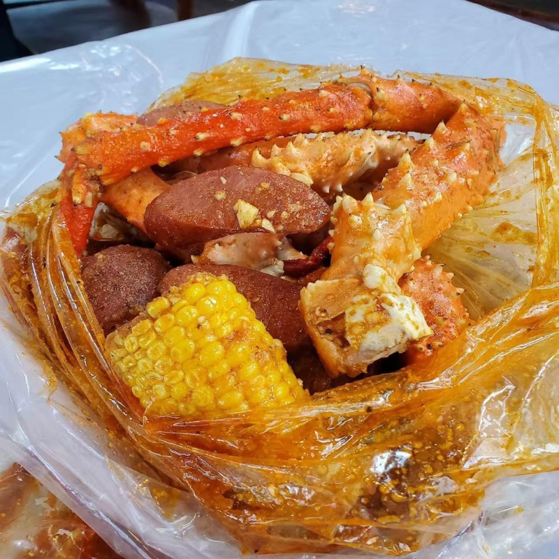 Seasoned king crab legs with corn and sausage at Cajun Express, a Seafood Restaurant in St Paul