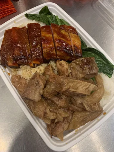 Roasted duck and braised pork rice combo with leafy greens at Canto House, a Chinese restaurant in Philadelphia