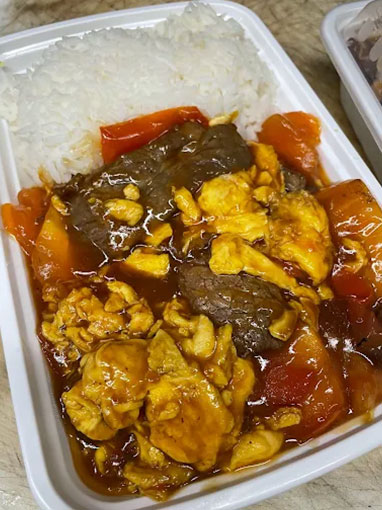 Beef and tomato egg stir-fry served over steamed rice at Canto House, a Chinese restaurant in Philadelphia