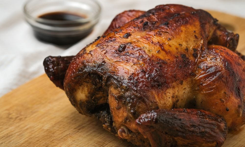 Whole roasted chicken with glossy skin, herbs, and soy sauce dipping at Canto House, a Chinese restaurant in Philadelphia