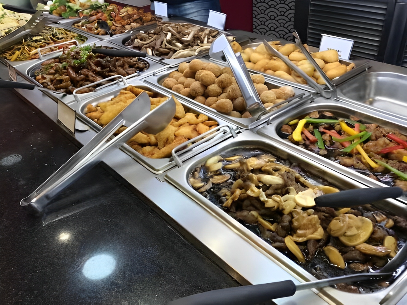 Hot Dish Buffet Various cooked dishes at a self - service counter at Captain Buffet, a Asian Fusion restaurant in Sacramento
