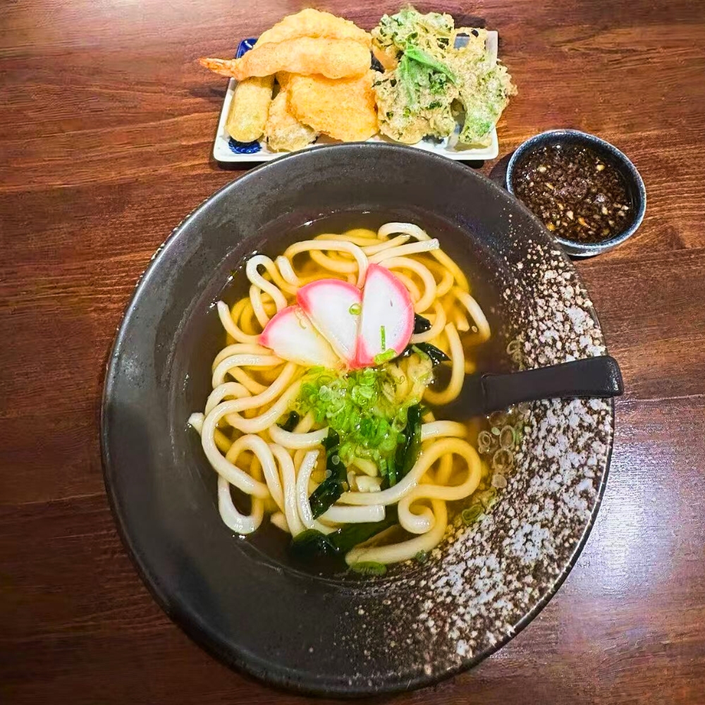 Udon noodles in broth with tempura platter and dipping sauce at Catzuneko Shokudo, a Japanese Restaurant in New York