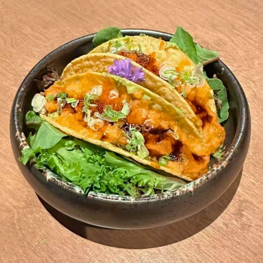 Salmon-filled tacos with masago, greens, and edible flower at Catzuneko Shokudo, a Japanese Restaurant in New York
