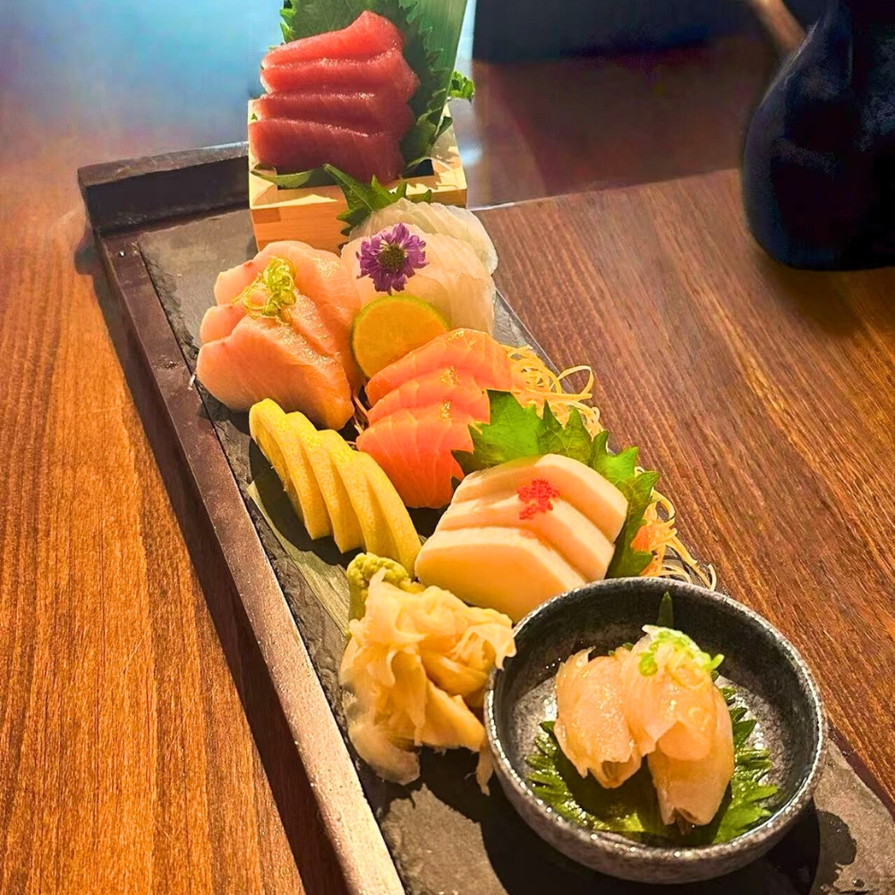Assorted premium sashimi with ginger, wasabi, and garnishes at Catzuneko Shokudo, a Japanese Restaurant in New York