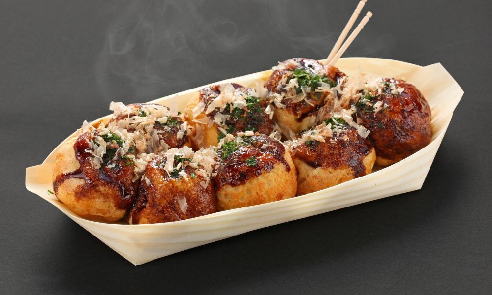 Takoyaki octopus balls with sauce, bonito flakes, and green onion garnish at Chef Ben Asian Cuisine & Ramen, a Asian fusion restaurant in Friendswood