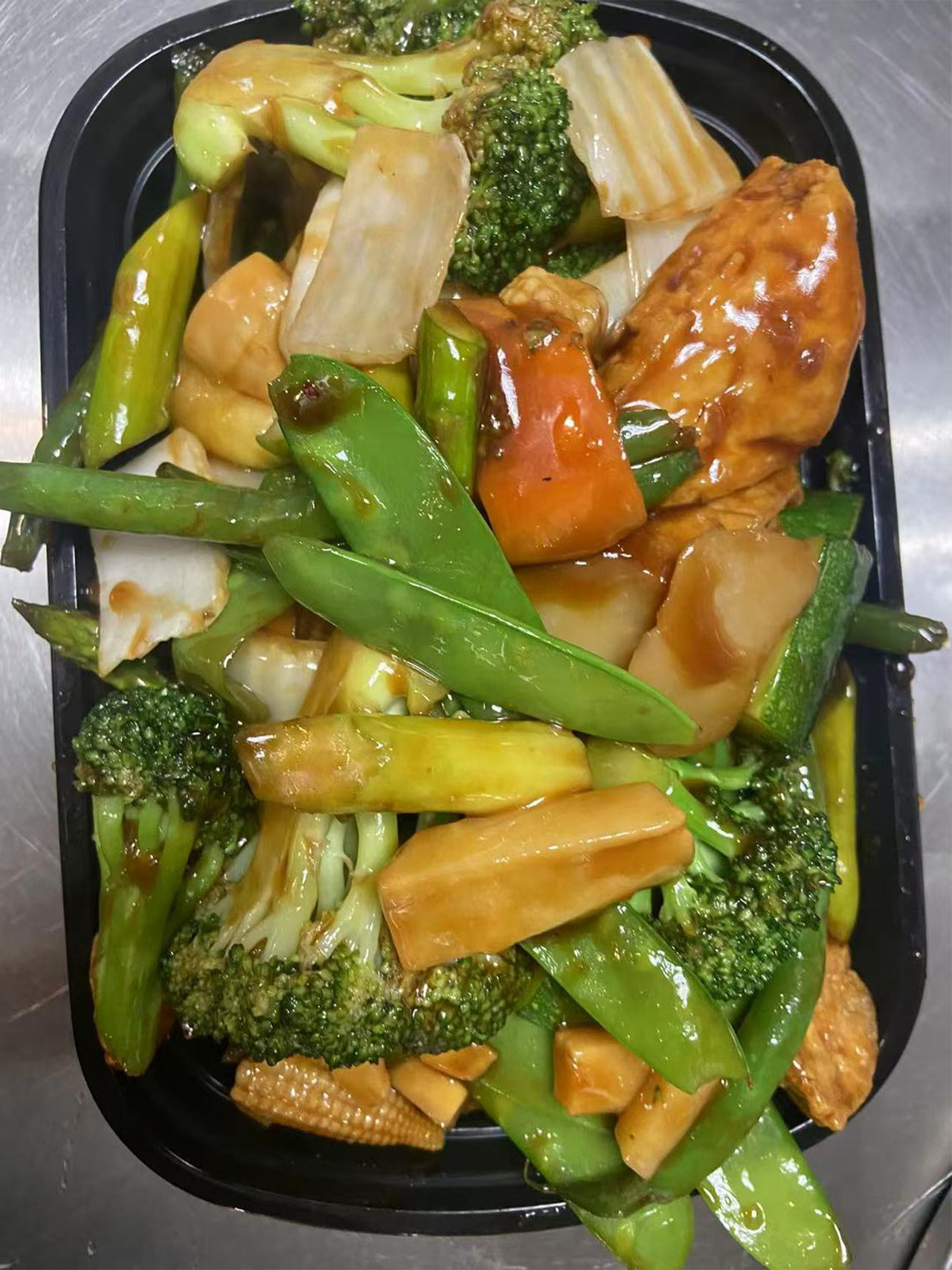 Mixed vegetable stir-fry with broccoli, baby corn, and snow peas