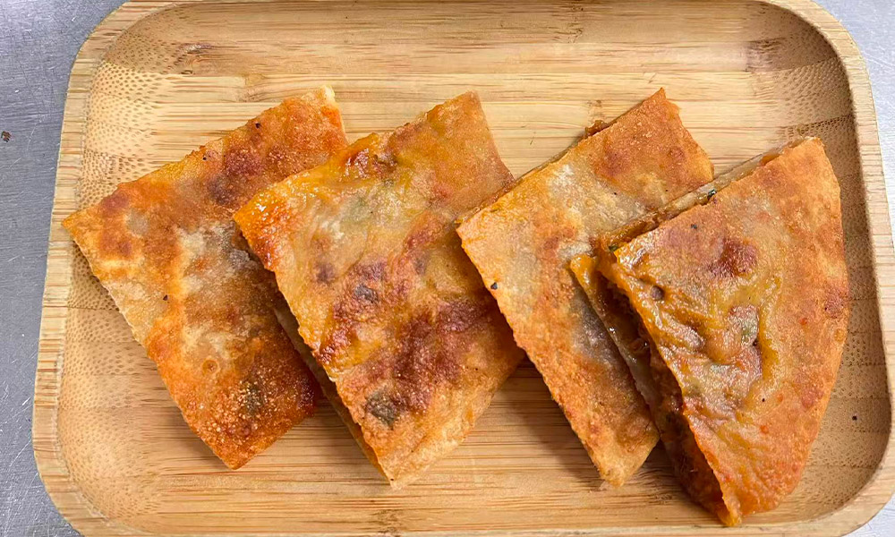 Crispy patties with savory pepper-flavored fresh meat filling at Chef Ge, a Chinese Restaurant in Highland Park