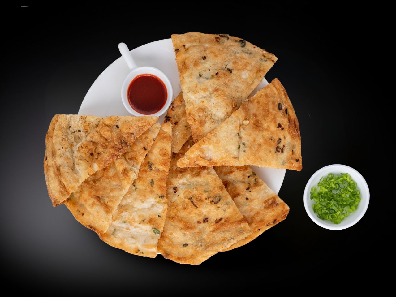Flaky scallion pancakes served with dipping sauce at Chef Gong Chinese Restaurant in Lansing