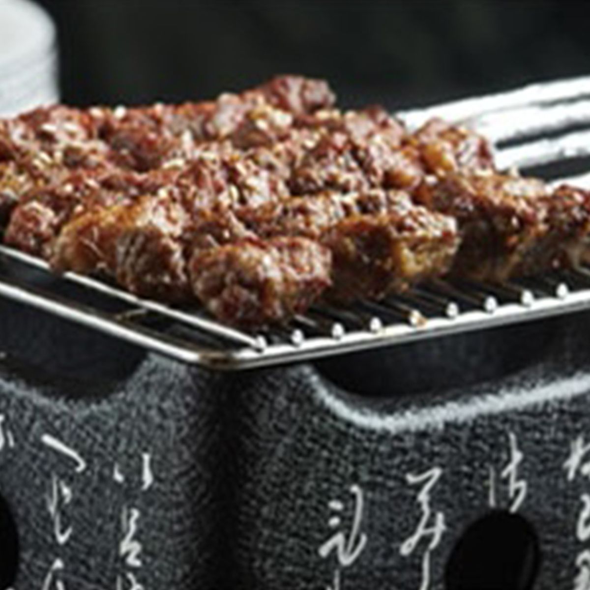 Grilled meat skewers with sesame seeds at Chef Huang, a Chinese Restaurant in New York