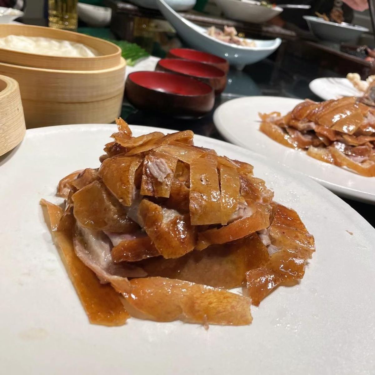 Sliced Peking duck on a white plate at Chef Huang, a Chinese Restaurant in New York