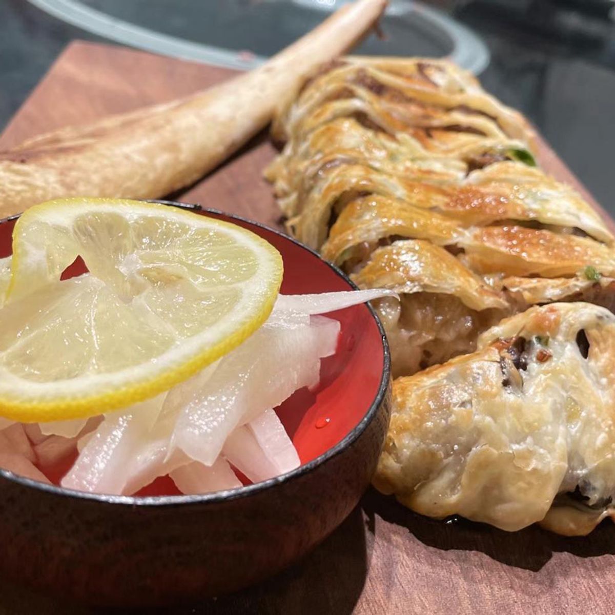 Flaky meat pastry with pickled ginger and lemon at Chef Huang, a Chinese Restaurant in New York