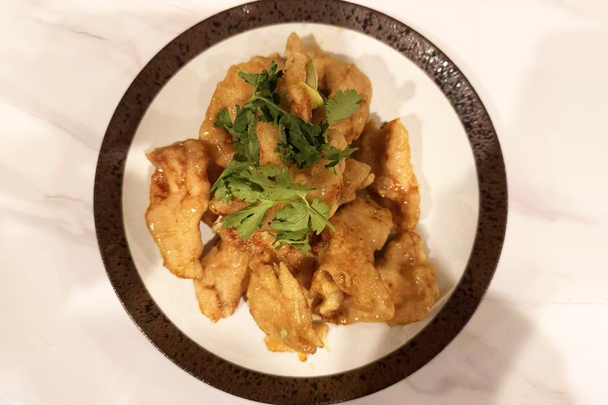 A classic dish from Northeast China. The battered pork slices are golden and glazed in a translucent, amber-colored Sweet and sour sauce, and served with carrots, scallion, ginger and cilantro at Chef Ma，a Chinese Restaurant in Edison