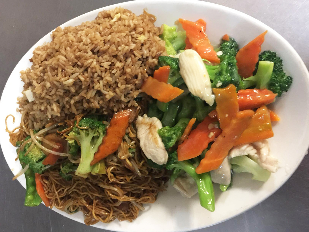 Cheng's-Restaurant-Chinese-Restaurant-combo-platter-Rochester-Hills A white plate containing fried rice, chow mein, and chicken stir - fried with broccoli and carrots at Cheng's Restaurant,a Chinese Restaurant in Rochester Hills