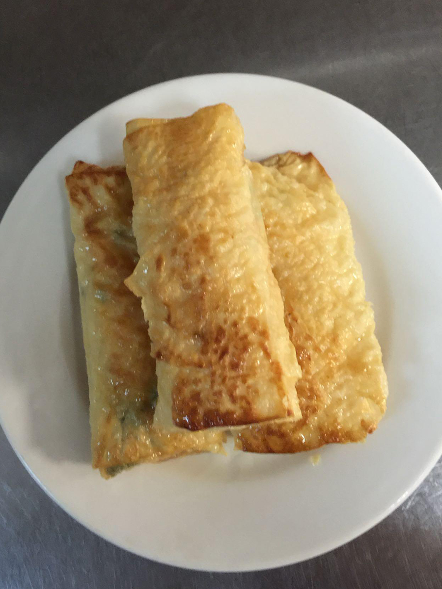 Three golden egg rolls placed on a white plate at Cheng's Restaurant，a Chinese Restaurant in Rochester Hills