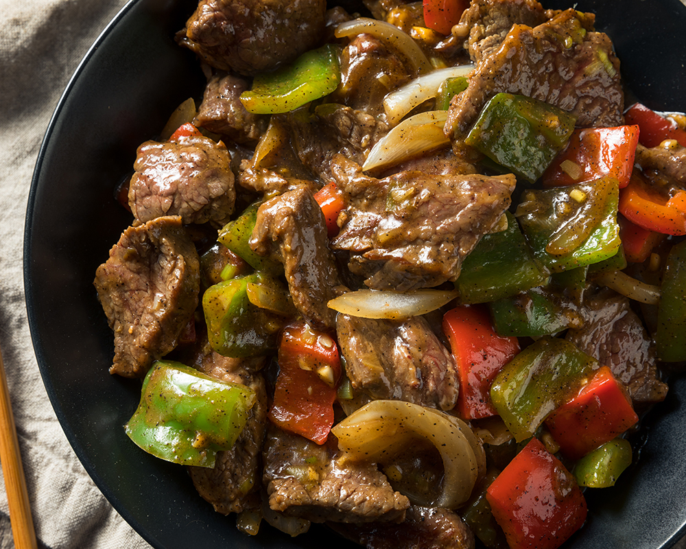 Glazed pepper onion beef stir fry in black bowl at Chen’s Wok, a Chinese Restaurant in Crowley Glazed pepper onion beef stir fry in black bowl at Chen’s Wok, a Chinese Restaurant in Crowley