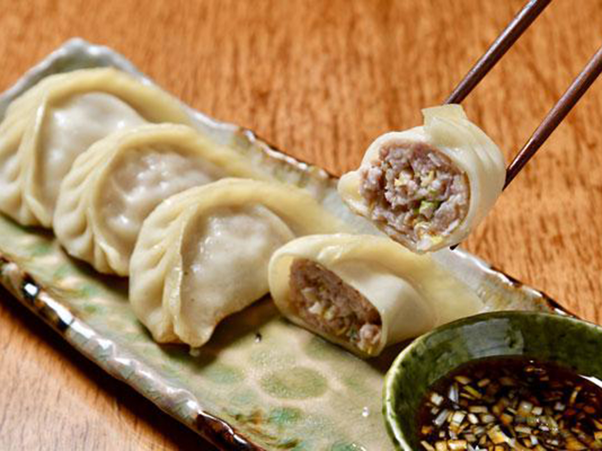 Juicy pork-filled dumplings with dipping sauce at China Flavor, a Dim Sum Restaurant in Lansing