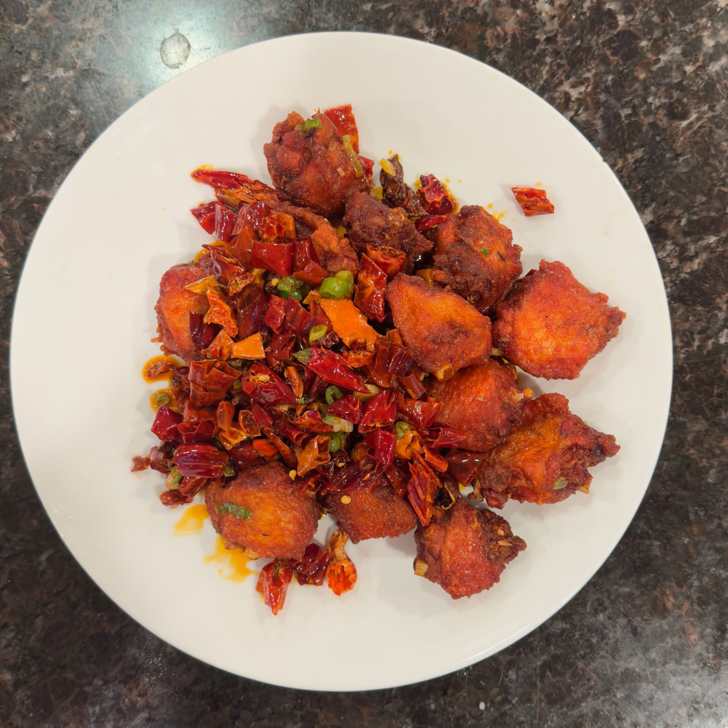 Crispy chicken cubes stir-fried with dried chili peppers for a spicy kick at China Palace Restaurant, a Chinese Restaurant in Milpitas
