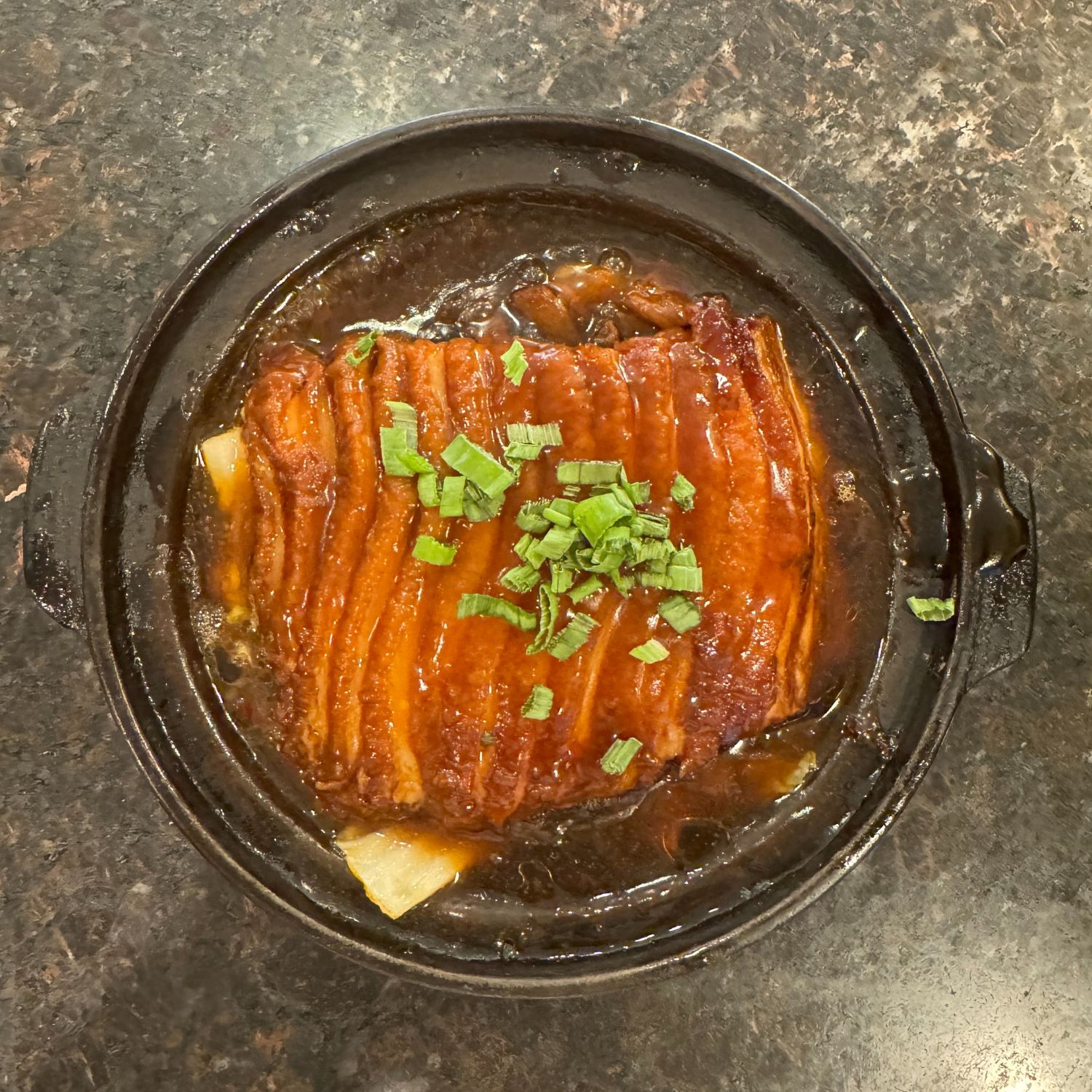 Tender braised pork belly in glossy brown sauce, garnished with scallions at China Palace Restaurant, a Chinese Restaurant in Milpitas