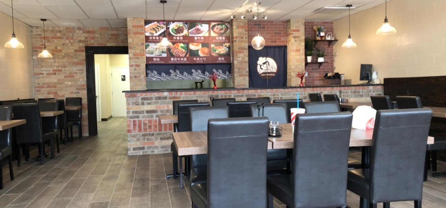 Cozy brick-themed dining space at Chinese Dumpling, a Chinese Restaurant in Midland