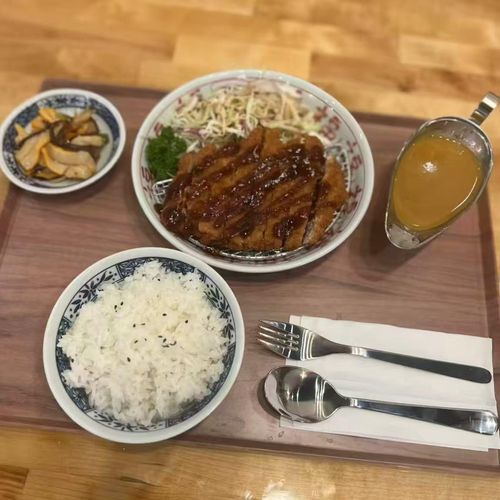 Chop-Bento-Asian-Restaurant-Japanese-Curry-Pork-Katsu-Oxford Rich and savory curry made with carrots, onions, and potatoes, simmered in a traditional Japanese roux. Mildly spiced and deeply comforting.