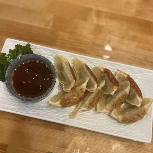 Chop-Bento-Asian-Restaurant-Gyoza-Oxford Pan-fried Japanese dumplings filled with juicy pork, cabbage, and green onion. — served with house dipping sauce.