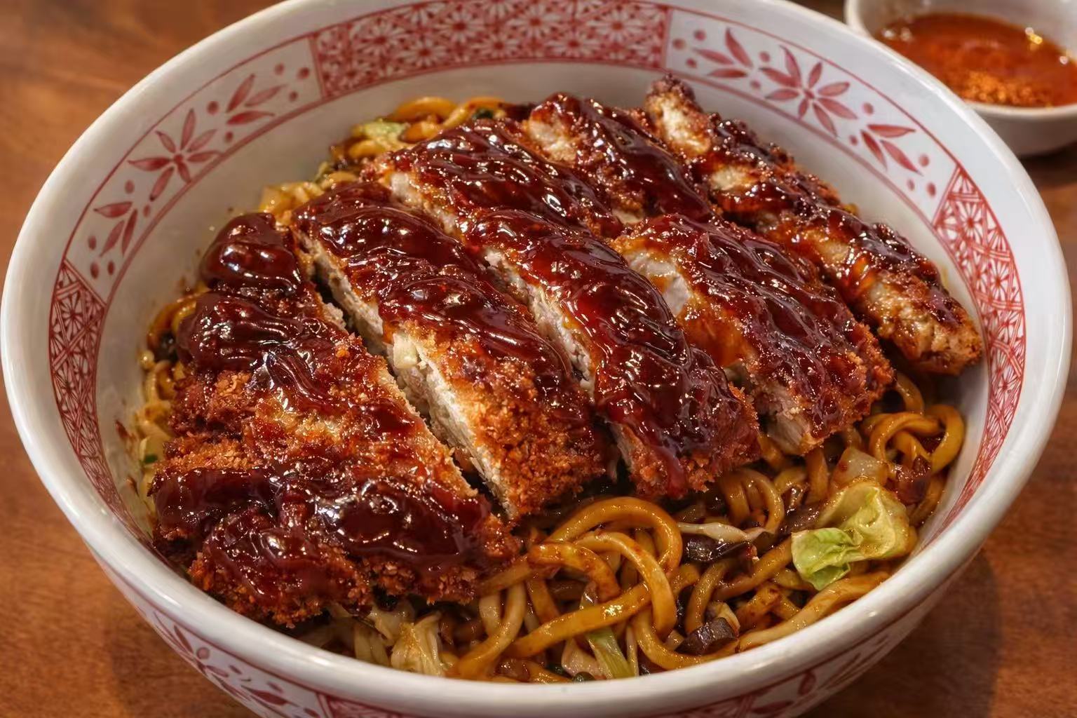 Crispy pork cutlet over stir-fried noodles at Chop Bento, a Asian Restaurant in Oxford