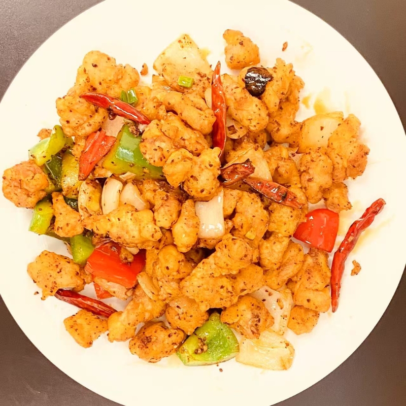 Kung Pao chicken with peppers and scallions, a spicy stir - fry.