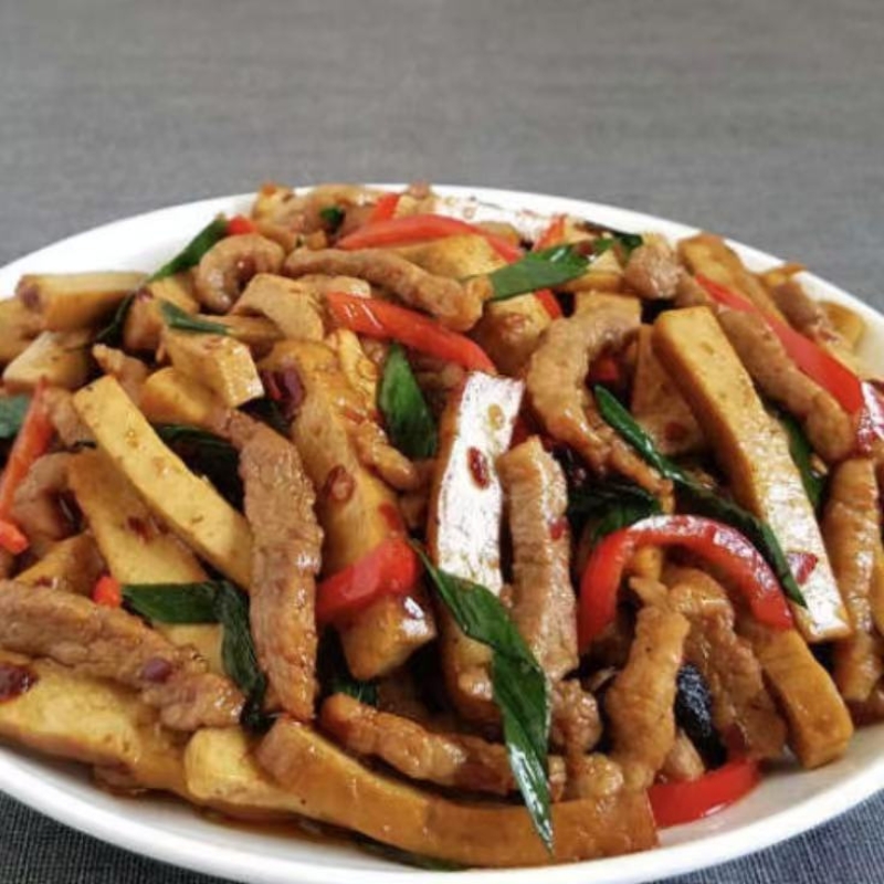 Shredded pork stir - fried with dried tofu, peppers and greens.