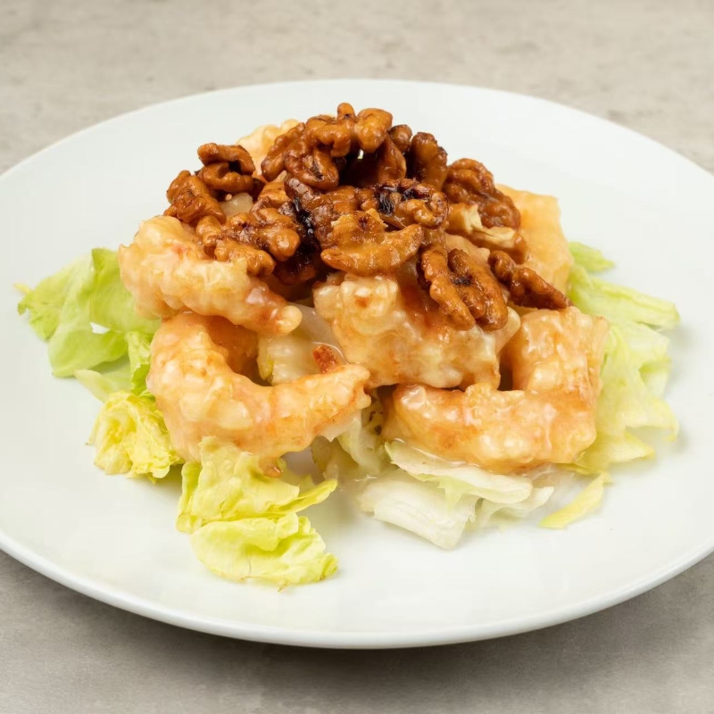 Prawns topped with walnuts, served on a bed of lettuce.