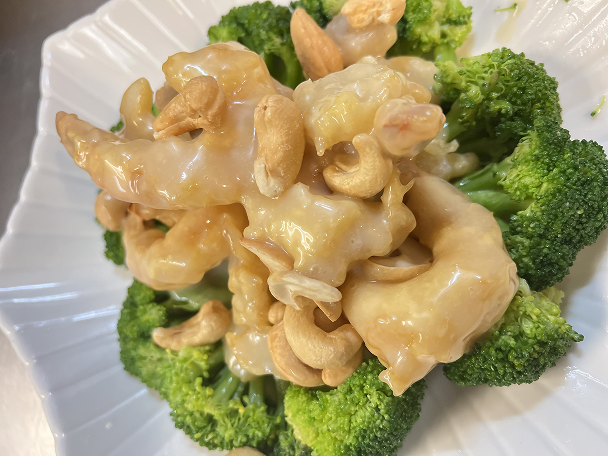 Chopsticks-Asian-Bistro-Asian-Restaurant-Crunchy-cashew-shrimp-Littleton Tender shrimp with cashews, glazed in sauce, served on a bed of fresh broccoli, presented on a white plate at Chopsticks Asian Bistro,a Asian Restaurant in Littleton