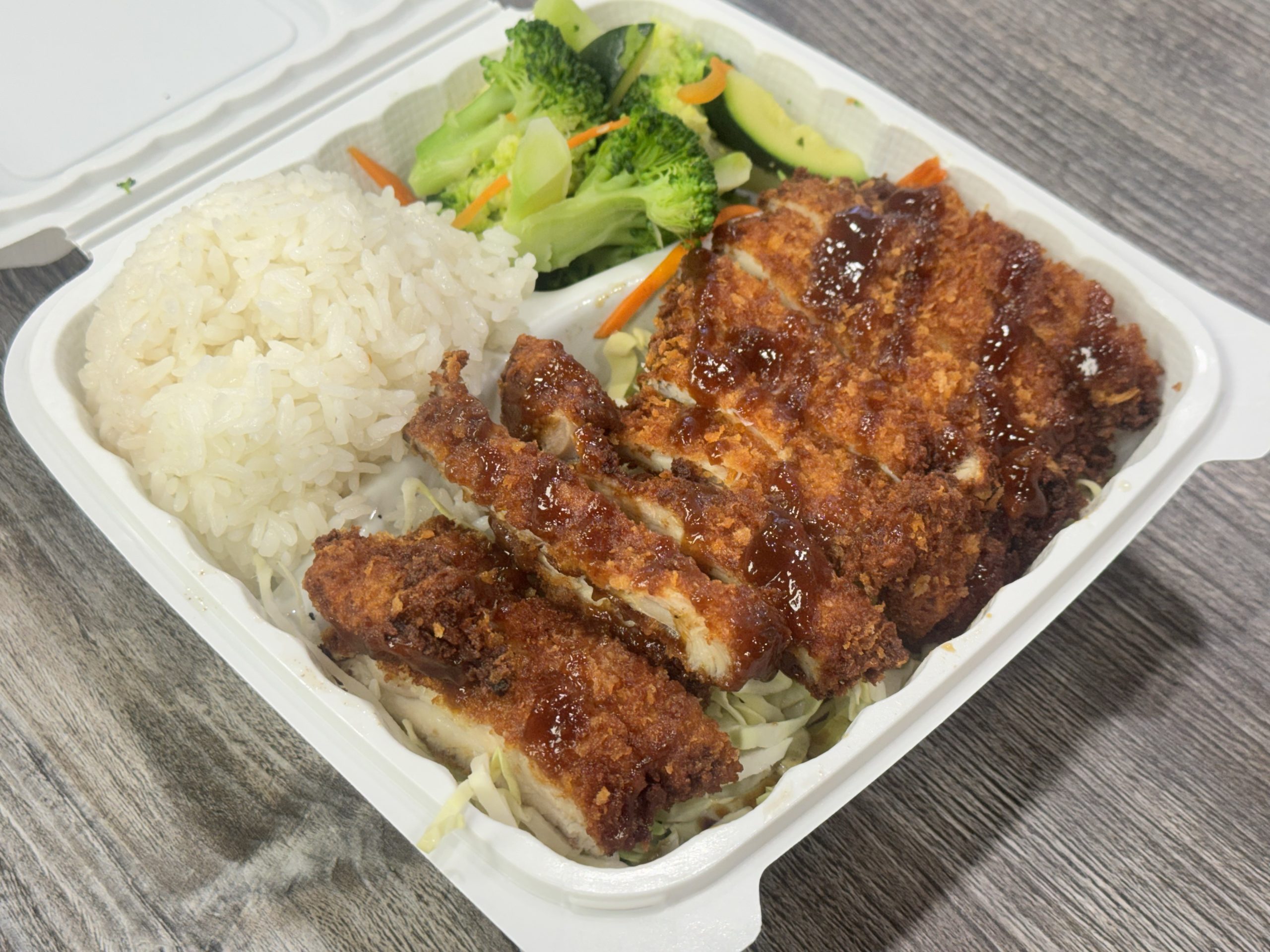 Crispy fried chicken cutlet with rice and veggies at Chop Sushi & Grill, a Japanese Restaurant in Los Angeles