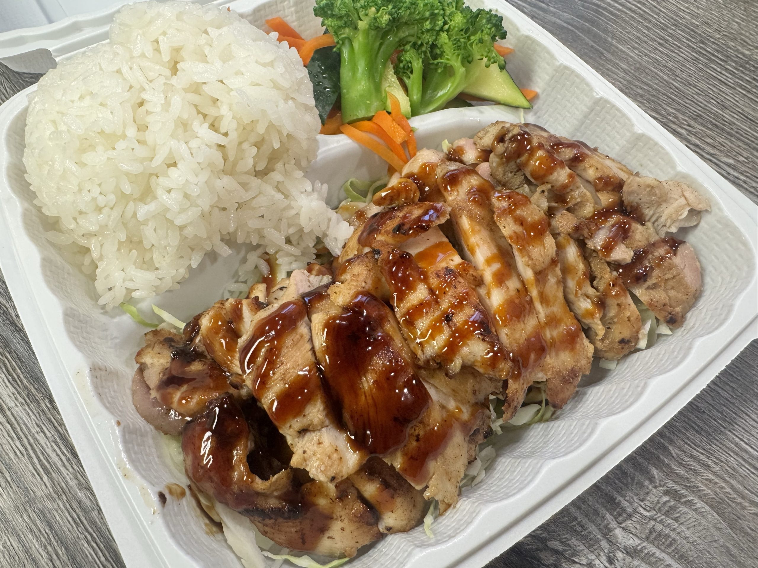 Juicy teriyaki chicken with rice and veggies at Chop Sushi & Grill, a Japanese Restaurant in Los Angeles