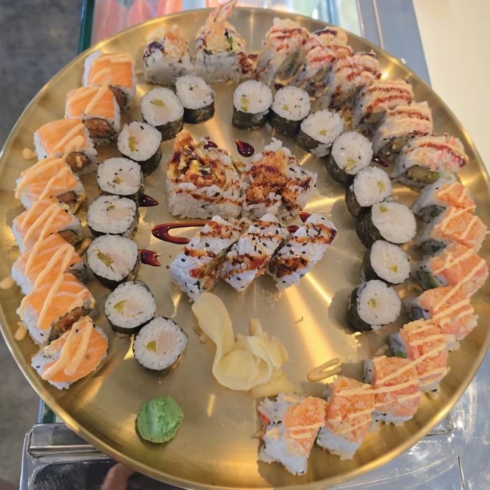 Assorted sushi rolls beautifully arranged on a golden plate at CK Kitchen, a Sushi Restaurant in Covington.