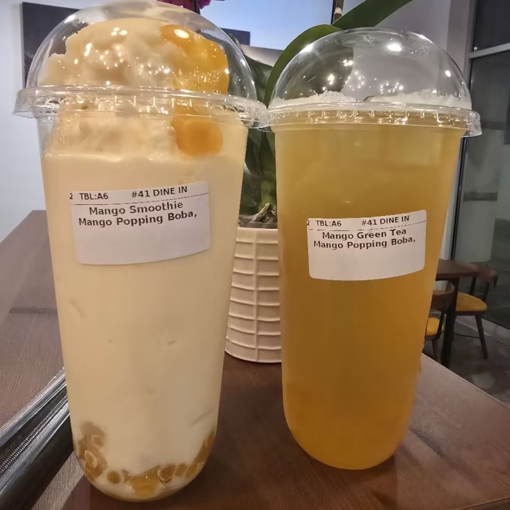 Two mango - based drinks, one smoothie and one green tea, at CK Kitchen, a Sushi Restaurant in Covington.