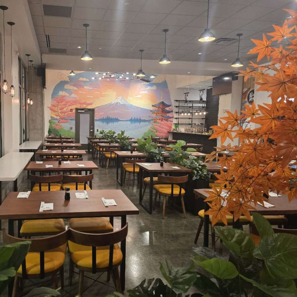 Well - lit dining area with Japanese - style mural at CK Kitchen, a Sushi Restaurant in Covington.