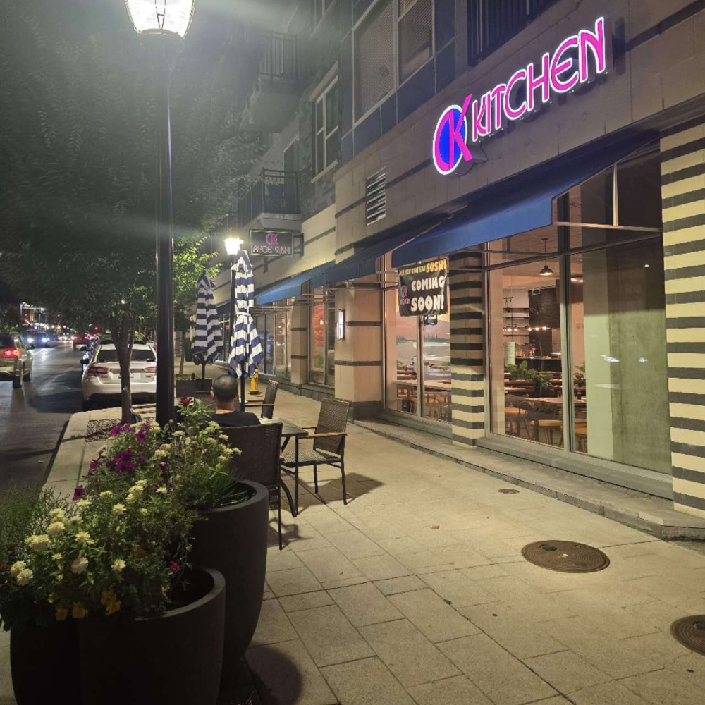 Night view of CK Kitchen's exterior with neon sign at CK Kitchen, a Sushi Restaurant in Covington.