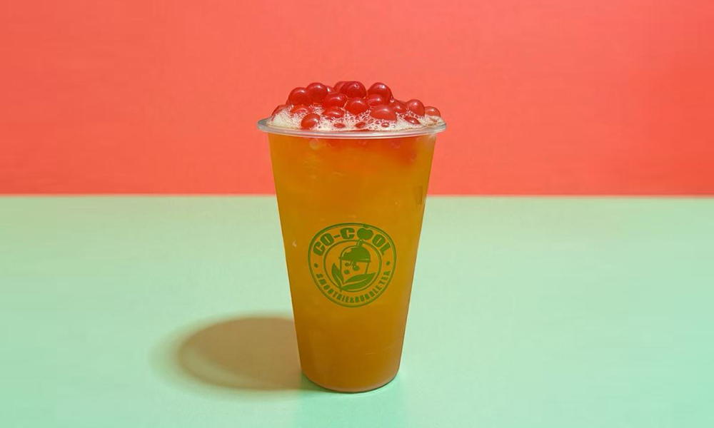 Co-cool-Smoothie-&-Bubble-Tea-Bubble-Red-Pearl-Orange-Fruit-Tea-Freehold Refreshing orange fruit tea with red pearls and ice at Co-cool Smoothie & Bubble Tea, a Bubble Tea Shop in Freehold