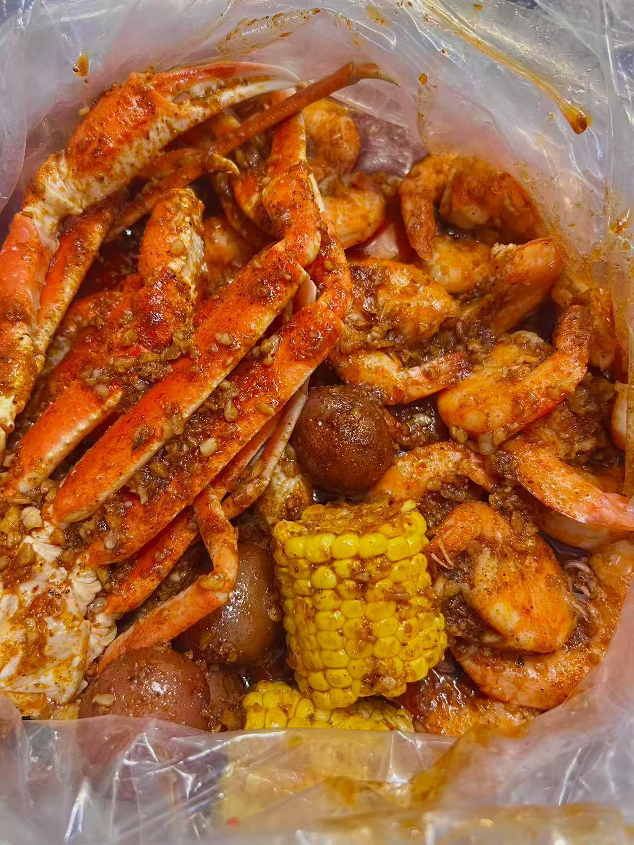 Close-up of a seafood bag with crab legs, shrimp, corn, and sausage