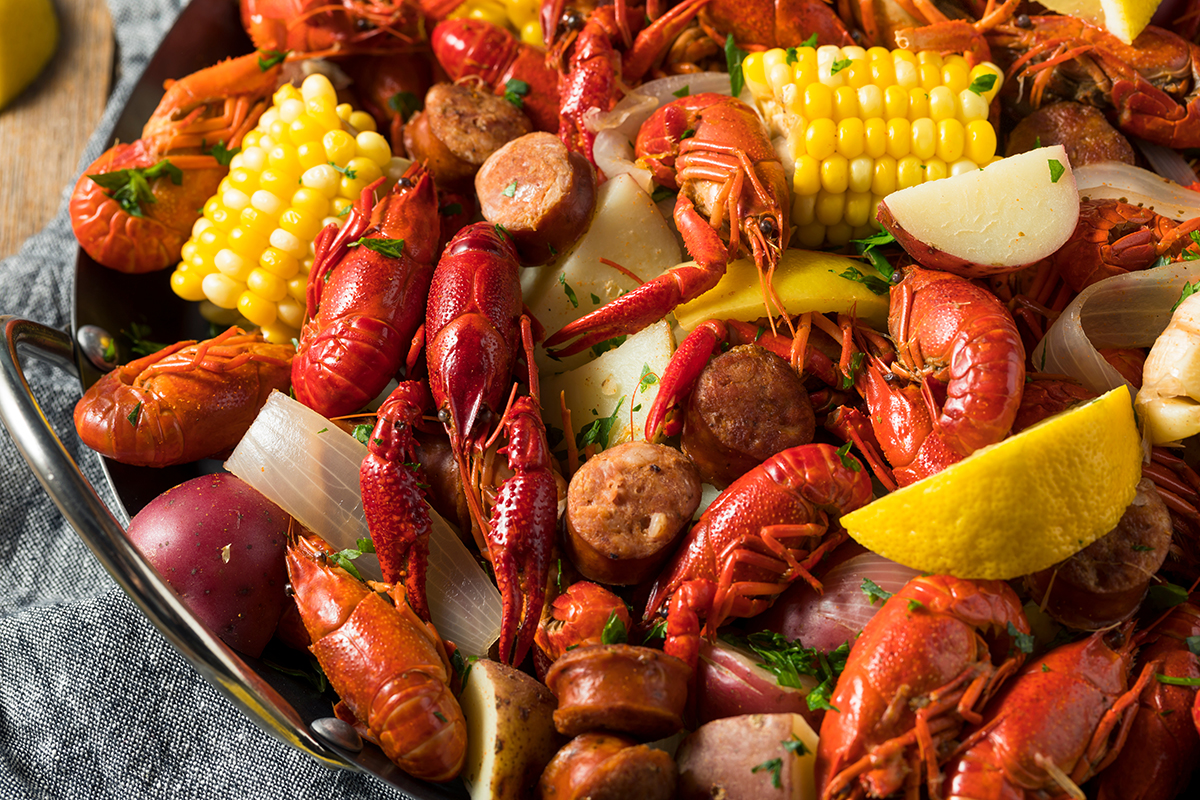 Traditional crawfish boil with corn potatoes sausage and lemon at Crabbers No.12, a Seafood Restaurant in Orlando