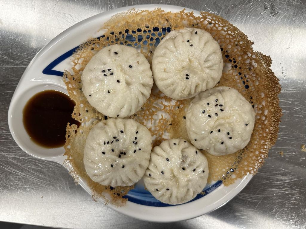 3+3-Lan-Zhou-Ramen-Chinese-restaurant-Shanghai-Pan-Fried-Pork-Bun-Cumming Pan - fried pork buns with crispy bottoms, topped with sesame seeds at 3+3 Lan Zhou Ramen, a Chinese restaurant in Cumming
