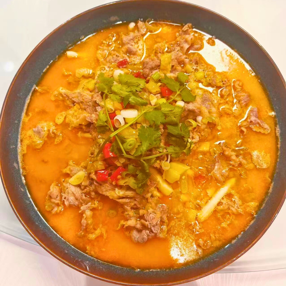 Sour soup with beef slices and herbs at Dallas Spicy Chinese Cuisine, a Chinese Restaurant in Plano.