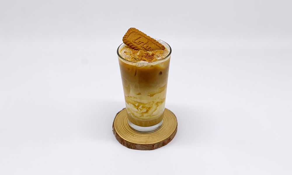 coffee mixed with Biscoff cookie flavor, topped with a cookie piece at Dandelion Kaffe，a Brunch Restaurant in Alameda