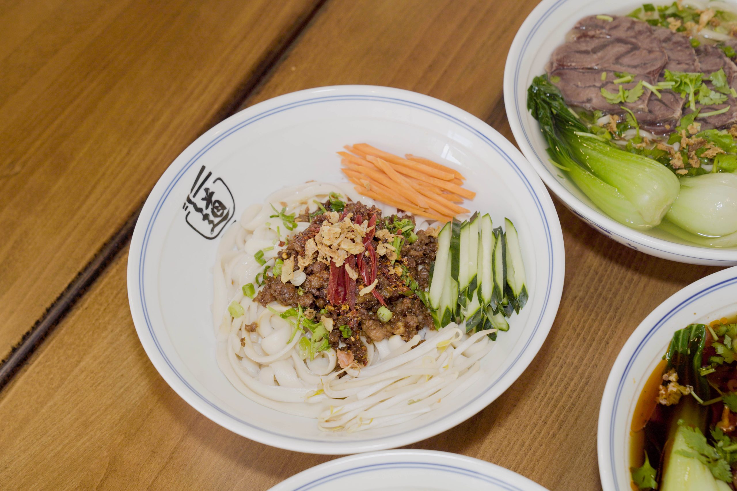 Dandan noodles with minced meat, cucumber, carrot strips, and spices at Dao Artisan Noodle, a Chinese Restaurant in San Leandro